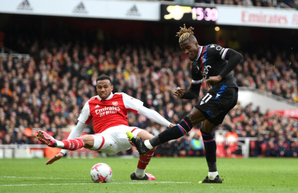 LONDON, ENGLAND - MARCH 19: Wilfried Zaha of Crystal Palace shoots whilst under pressure from Gabriel of Arsenal during the Premier League match between Arsenal FC and Crystal Palace at Emirates Stadium on March 19, 2023 in London, England. (Photo by Shaun Botterill/Getty Images)