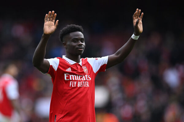 Arsenal's English midfielder Bukayo Saka gestures to fans on the pitch after the English Premier League football match between Arsenal and Crystal Palace at the Emirates Stadium in London on March 19, 2023. - Arsenal won the game 4-1. (Photo by JUSTIN TALLIS / AFP) / RESTRICTED TO EDITORIAL USE. No use with unauthorized audio, video, data, fixture lists, club/league logos or 'live' services. Online in-match use limited to 120 images. An additional 40 images may be used in extra time. No video emulation. Social media in-match use limited to 120 images. An additional 40 images may be used in extra time. No use in betting publications, games or single club/league/player publications. / (Photo by JUSTIN TALLIS/AFP via Getty Images)