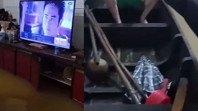 广东男家中淹水 淡定坐渔船看电视（视频）