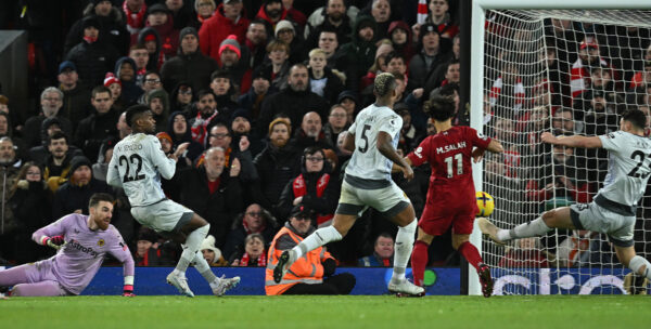 Wolverhampton Wanderers' Portuguese goalkeeper Jose Sa (L) looks on as Liverpool's Egyptian striker Mohamed Salah (2R) scores the team's second goal during the English Premier League football match between Liverpool and Wolverhampton at Anfield in Liverpool, north west England on March 1, 2023. (Photo by Paul ELLIS / AFP) / RESTRICTED TO EDITORIAL USE. No use with unauthorized audio, video, data, fixture lists, club/league logos or 'live' services. Online in-match use limited to 120 images. An additional 40 images may be used in extra time. No video emulation. Social media in-match use limited to 120 images. An additional 40 images may be used in extra time. No use in betting publications, games or single club/league/player publications. / 