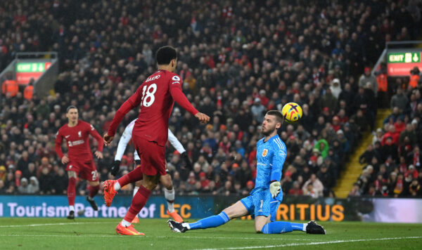 LIVERPOOL, ENGLAND - MARCH 05: Cody Gakpo of Liverpool scores the team's third goal as David De Gea of Manchester United attempts to make a save during the Premier League match between Liverpool FC and Manchester United at Anfield on March 05, 2023 in Liverpool, England. 