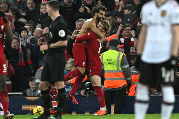 Liverpool's Egyptian striker Mohamed Salah (centre left) celebrates with Liverpool's English midfielder Harvey Elliott (centre right) after scoring their sixth goal during the English Premier League football match between Liverpool and Manchester United at Anfield in Liverpool, north west England on March 5, 2023. (Photo by Paul ELLIS / AFP) / RESTRICTED TO EDITORIAL USE. No use with unauthorized audio, video, data, fixture lists, club/league logos or 'live' services. Online in-match use limited to 120 images. An additional 40 images may be used in extra time. No video emulation. Social media in-match use limited to 120 images. An additional 40 images may be used in extra time. No use in betting publications, games or single club/league/player publications. / (Photo by PAUL ELLIS/AFP via Getty Images)