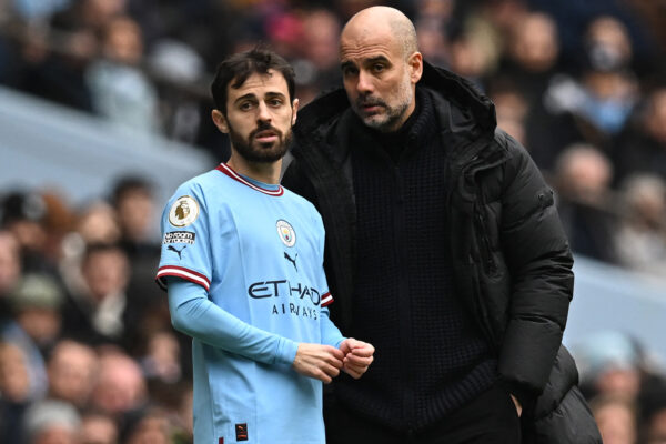 Manchester City's Spanish manager Pep Guardiola (R) speaks with Manchester City's Portuguese midfielder Bernardo Silva (L) before bringing him on as a substitute during the English Premier League football match between Manchester City and Newcastle United at the Etihad Stadium in Manchester, north west England, on March 4, 2023. (Photo by Paul ELLIS / AFP) / RESTRICTED TO EDITORIAL USE. No use with unauthorized audio, video, data, fixture lists, club/league logos or 'live' services. Online in-match use limited to 120 images. An additional 40 images may be used in extra time. No video emulation. Social media in-match use limited to 120 images. An additional 40 images may be used in extra time. No use in betting publications, games or single club/league/player publications. / (Photo by PAUL ELLIS/AFP via Getty Images)