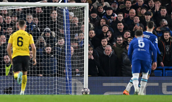 Chelsea's German midfielder Kai Havertz (R) watches his penalty hit the post, before Chelsea were allowed to re-take it following a VAR review, during the UEFA Champions League round of 16 second-leg football match between Chelsea and Borrusia Dortmund at Stamford Bridge in London on March 7, 2023. (Photo by Glyn KIRK / IKIMAGES / AFP) (Photo by GLYN KIRK/IKIMAGES/AFP via Getty Images)