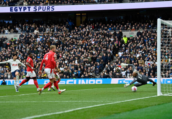 Tottenham Hotspur's South Korean striker Son Heung-Min (L) scores the team's third goal during the English Premier League football match between Tottenham Hotspur and Nottingham Forest at Tottenham Hotspur Stadium in London, on March 11, 2023. (Photo by JUSTIN TALLIS / AFP) / RESTRICTED TO EDITORIAL USE. No use with unauthorized audio, video, data, fixture lists, club/league logos or 'live' services. Online in-match use limited to 120 images. An additional 40 images may be used in extra time. No video emulation. Social media in-match use limited to 120 images. An additional 40 images may be used in extra time. No use in betting publications, games or single club/league/player publications. / (Photo by JUSTIN TALLIS/AFP via Getty Images)