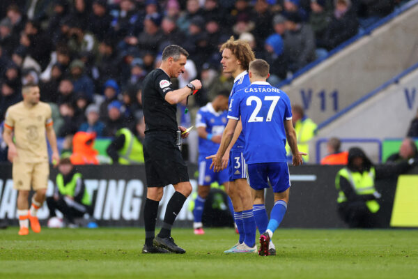 LEICESTER, ENGLAND - MARCH 11: Referee Andre Marriner shows a red card to Wout Faes of Leicester City during the Premier League match between Leicester City and Chelsea FC at The King Power Stadium on March 11, 2023 in Leicester, England. (Photo by Marc Atkins/Getty Images)