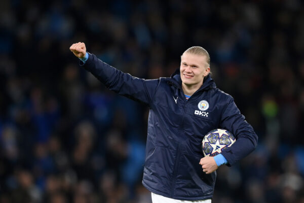 MANCHESTER, ENGLAND - MARCH 14: Erling Haaland of Manchester City celebrates victory with their match ball after scoring a hat-trick in the UEFA Champions League round of 16 leg two match between Manchester City and RB Leipzig at Etihad Stadium on March 14, 2023 in Manchester, England. (Photo by Shaun Botterill/Getty Images)