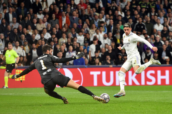 MADRID, SPAIN - MARCH 15: Federico Valverde of Real Madrid has a shot saved by Alisson Becker of Liverpool during the UEFA Champions League round of 16 leg two match between Real Madrid and Liverpool FC at Estadio Santiago Bernabeu on March 15, 2023 in Madrid, Spain. (Photo by Denis Doyle/Getty Images)