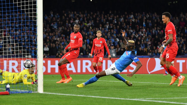 Napoli's Nigerian forward Victor Osimhen (C) scores his side's second goal past Frankfurt's German goalkeeper Kevin Trapp (L) during the UEFA Champions League round of 16, second leg football match between SSC Napoli and Eintracht Frankfurt at the Diego-Maradona stadium in Naples on March 15, 2023. (Photo by Tiziana FABI / AFP) (Photo by TIZIANA FABI/AFP via Getty Images)