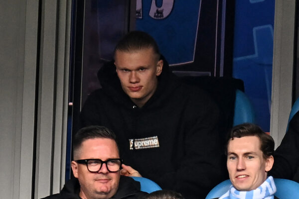 Manchester City's Norwegian striker Erling Haaland looks on from his seat, missing the game through injury during the English Premier League football match between Manchester City and Liverpool at the Etihad Stadium in Manchester, north west England, on April 1, 2023. (Photo by Paul ELLIS / AFP) / RESTRICTED TO EDITORIAL USE. No use with unauthorized audio, video, data, fixture lists, club/league logos or 'live' services. Online in-match use limited to 120 images. An additional 40 images may be used in extra time. No video emulation. Social media in-match use limited to 120 images. An additional 40 images may be used in extra time. No use in betting publications, games or single club/league/player publications. / (Photo by PAUL ELLIS/AFP via Getty Images)