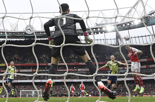 Arsenal's Swiss midfielder Granit Xhaka (R) scores their fourth goal from this header during the English Premier League football match between Arsenal and Leeds United at the Emirates Stadium in London on April 1, 2023. (Photo by Glyn KIRK / AFP) / RESTRICTED TO EDITORIAL USE. No use with unauthorized audio, video, data, fixture lists, club/league logos or 'live' services. Online in-match use limited to 120 images. An additional 40 images may be used in extra time. No video emulation. Social media in-match use limited to 120 images. An additional 40 images may be used in extra time. No use in betting publications, games or single club/league/player publications. / (Photo by GLYN KIRK/AFP via Getty Images)