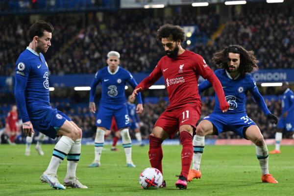 Liverpool's Egyptian striker Mohamed Salah (C) vies with Chelsea's English defender Ben Chilwell (L) and Chelsea's Spanish defender Marc Cucurella (R) during the English Premier League football match between Chelsea and Liverpool at Stamford Bridge in London on April 4, 2023. (Photo by Glyn KIRK / AFP) / RESTRICTED TO EDITORIAL USE. No use with unauthorized audio, video, data, fixture lists, club/league logos or 'live' services. Online in-match use limited to 120 images. An additional 40 images may be used in extra time. No video emulation. Social media in-match use limited to 120 images. An additional 40 images may be used in extra time. No use in betting publications, games or single club/league/player publications. / (Photo by GLYN KIRK/AFP via Getty Images)