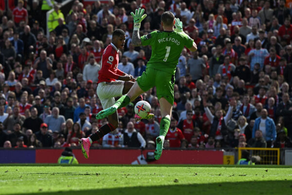 Everton's English goalkeeper Jordan Pickford (R) saves a shot from Manchester United's English striker Marcus Rashford during the English Premier League football match between Manchester United and Everton at Old Trafford in Manchester, north west England, on April 8, 2023. (Photo by Paul ELLIS / AFP) / RESTRICTED TO EDITORIAL USE. No use with unauthorized audio, video, data, fixture lists, club/league logos or 'live' services. Online in-match use limited to 120 images. An additional 40 images may be used in extra time. No video emulation. Social media in-match use limited to 120 images. An additional 40 images may be used in extra time. No use in betting publications, games or single club/league/player publications. / (Photo by PAUL ELLIS/AFP via Getty Images)