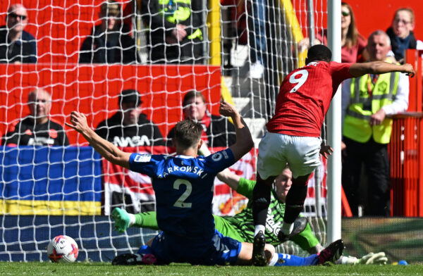 Manchester United's French striker Anthony Martial (R) scores the team's second goal past Everton's English goalkeeper Jordan Pickford during the English Premier League football match between Manchester United and Everton at Old Trafford in Manchester, north west England, on April 8, 2023. (Photo by Paul ELLIS / AFP) / RESTRICTED TO EDITORIAL USE. No use with unauthorized audio, video, data, fixture lists, club/league logos or 'live' services. Online in-match use limited to 120 images. An additional 40 images may be used in extra time. No video emulation. Social media in-match use limited to 120 images. An additional 40 images may be used in extra time. No use in betting publications, games or single club/league/player publications. / (Photo by PAUL ELLIS/AFP via Getty Images)