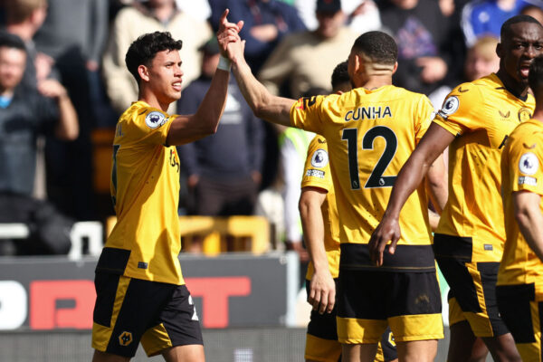 Wolverhampton Wanderers' Brazilian midfielder Matheus Nunes (L) celebrates with teammates after scoring the opening goal of the English Premier League football match between Wolverhampton Wanderers and Chelsea at the Molineux stadium in Wolverhampton, central England on April 8, 2023. (Photo by Darren Staples / AFP) / RESTRICTED TO EDITORIAL USE. No use with unauthorized audio, video, data, fixture lists, club/league logos or 'live' services. Online in-match use limited to 120 images. An additional 40 images may be used in extra time. No video emulation. Social media in-match use limited to 120 images. An additional 40 images may be used in extra time. No use in betting publications, games or single club/league/player publications. / (Photo by DARREN STAPLES/AFP via Getty Images)