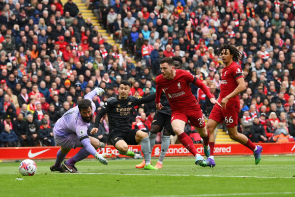 LIVERPOOL, ENGLAND - APRIL 09: Gabriel Martinelli of Arsenal scores the team's first goal as Alisson Becker of Liverpool fails to make a save during the Premier League match between Liverpool FC and Arsenal FC at Anfield on April 09, 2023 in Liverpool, England. (Photo by Shaun Botterill/Getty Images)