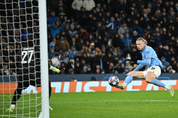 Manchester City's Norwegian striker Erling Haaland shoots to score their third goal during the UEFA Champions League quarter final, first leg football match between Manchester City and Bayern Munich at the Etihad Stadium in Manchester, north-west England, on April 11, 2023. 
