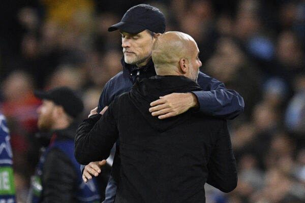 Bayern Munich's German head coach Thomas Tuchel (L) and Manchester City's Spanish manager Pep Guardiola (R) embrace after the UEFA Champions League quarter final, first leg football match between Manchester City and Bayern Munich at the Etihad Stadium in Manchester, north-west England, on April 11, 2023. - Manchester City won the game 3-0. (Photo by Oli SCARFF / AFP) 