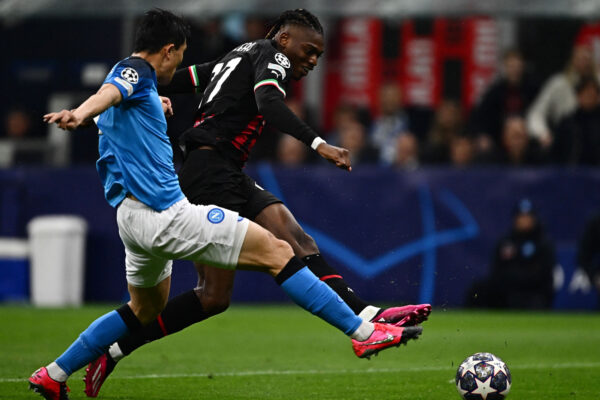 AC Milan's Portuguese forward Rafael Leao challenges Napoli's South Korean defender Min-jae Kim (L) during the UEFA Champions League quarter-finals first leg football match between AC Milan and SSC Napoli on April 12, 2023 at the San Siro stadium in Milan. (Photo by GABRIEL BOUYS / AFP) 