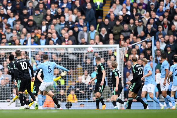 MANCHESTER, ENGLAND - APRIL 15: John Stones of Manchester City scores the team's first goal during the Premier League match between Manchester City and Leicester City at Etihad Stadium on April 15, 2023 in Manchester, England. 
