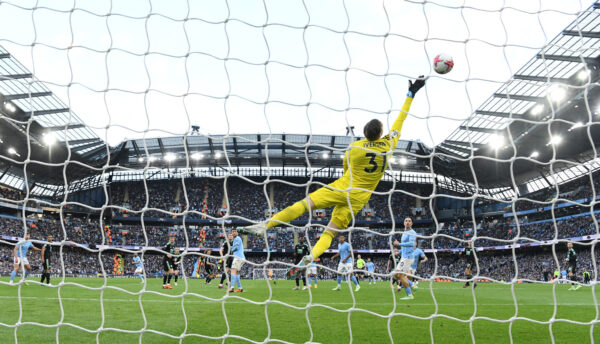 MANCHESTER, ENGLAND - APRIL 15: Leicester City goalkeeper Daniel Iverson makes a finger tip diving save during the Premier League match between Manchester City and Leicester City at Etihad Stadium on April 15, 2023 in Manchester, England. 