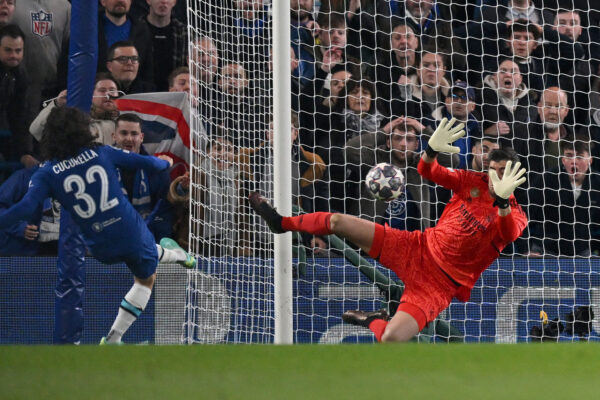 Real Madrid's Belgian goalkeeper Thibaut Courtois (R) savers a shot from Chelsea's Spanish defender Marc Cucurella during the Champions League quarter-final second-leg football match between Chelsea and Real Madrid at Stamford Bridge in London on April 18, 2023. (Photo by Glyn KIRK / AFP) 