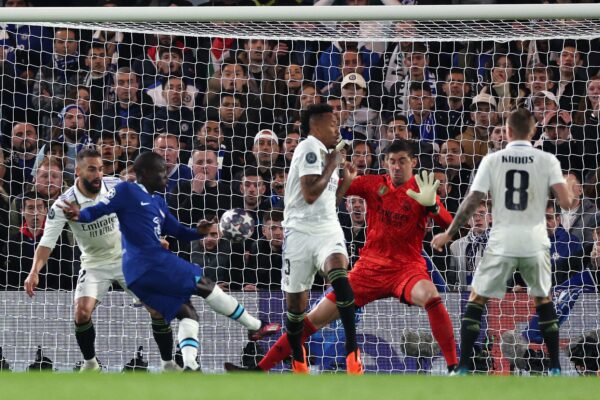 Real Madrid's Belgian goalkeeper Thibaut Courtois saves a shot from Chelsea's French midfielder N'Golo Kante during the Champions League quarter-final second-leg football match between Chelsea and Real Madrid at Stamford Bridge in London on April 18, 2023. (Photo by Adrian DENNIS / AFP) 