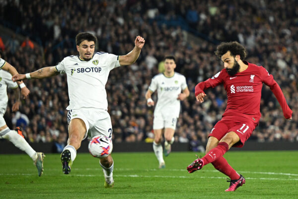 Liverpool's Egyptian striker Mohamed Salah (R) shoots to score their second goal during the English Premier League football match between Leeds United and Liverpool at Elland Road in Leeds, northern England on April 17, 2023. (Photo by Oli SCARFF / AFP) / RESTRICTED TO EDITORIAL USE. No use with unauthorized audio, video, data, fixture lists, club/league logos or 'live' services. Online in-match use limited to 120 images. An additional 40 images may be used in extra time. No video emulation. Social media in-match use limited to 120 images. An additional 40 images may be used in extra time. No use in betting publications, games or single club/league/player publications. / 