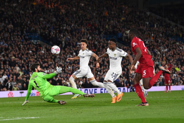 LEEDS, ENGLAND - APRIL 17: Luis Sinisterra of Leeds United scores the team's first goal past Alisson Becker and Ibrahima Konate of Liverpool during the Premier League match between Leeds United and Liverpool FC at Elland Road on April 17, 2023 in Leeds, England. (Photo by Stu Forster/Getty Images)