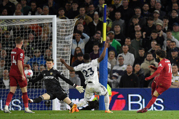 Liverpool's Egyptian striker Mohamed Salah (R) shoots to score their fourth goal during the English Premier League football match between Leeds United and Liverpool at Elland Road in Leeds, northern England on April 17, 2023. (Photo by Oli SCARFF / AFP) / RESTRICTED TO EDITORIAL USE. No use with unauthorized audio, video, data, fixture lists, club/league logos or 'live' services. Online in-match use limited to 120 images. An additional 40 images may be used in extra time. No video emulation. Social media in-match use limited to 120 images. An additional 40 images may be used in extra time. No use in betting publications, games or single club/league/player publications. / (Photo by OLI SCARFF/AFP via Getty Images)