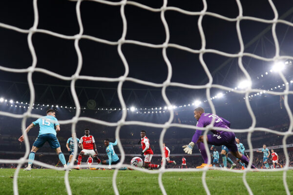 LONDON, ENGLAND - APRIL 21: Bukayo Saka of Arsenal scores the team's third goal past Gavin Bazunu of Southampton during the Premier League match between Arsenal FC and Southampton FC at Emirates Stadium on April 21, 2023 in London, England. 