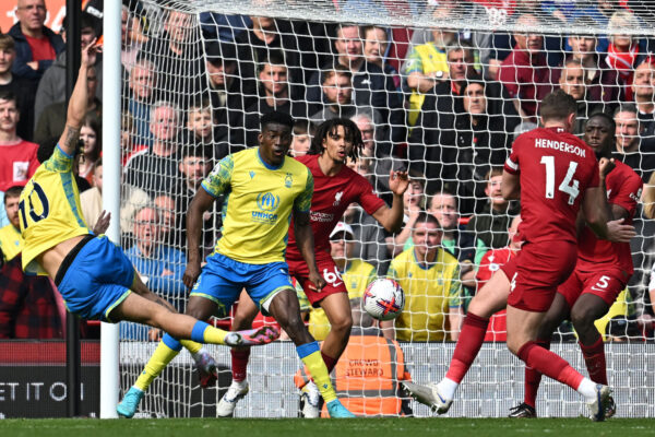 Nottingham Forest's English midfielder Morgan Gibbs-White (L) shoots to score their second goal during the English Premier League football match between Liverpool and Nottingham Forest at Anfield in Liverpool, north west England on April 22, 2023. (Photo by Paul ELLIS / AFP) / RESTRICTED TO EDITORIAL USE. No use with unauthorized audio, video, data, fixture lists, club/league logos or 'live' services. Online in-match use limited to 120 images. An additional 40 images may be used in extra time. No video emulation. Social media in-match use limited to 120 images. An additional 40 images may be used in extra time. No use in betting publications, games or single club/league/player publications. / 