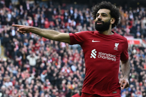 Liverpool's Egyptian striker Mohamed Salah celebrates after scoring their third goal during the English Premier League football match between Liverpool and Nottingham Forest at Anfield in Liverpool, north west England on April 22, 2023. (Photo by Paul ELLIS / AFP) / RESTRICTED TO EDITORIAL USE. No use with unauthorized audio, video, data, fixture lists, club/league logos or 'live' services. Online in-match use limited to 120 images. An additional 40 images may be used in extra time. No video emulation. Social media in-match use limited to 120 images. An additional 40 images may be used in extra time. No use in betting publications, games or single club/league/player publications. / 