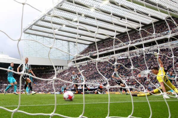 NEWCASTLE UPON TYNE, ENGLAND - APRIL 23: Harry Kane of Tottenham Hotspur scores the team's first goal past Nick Pope of Newcastle United during the Premier League match between Newcastle United and Tottenham Hotspur at St. James Park on April 23, 2023 in Newcastle upon Tyne, England. 
