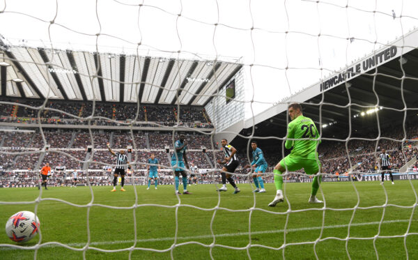 NEWCASTLE UPON TYNE, ENGLAND - APRIL 23: Newcastle striker Callum Wilson scores the 6th goal past Spurs goalkeeper Fraser Forster during the Premier League match between Newcastle United and Tottenham Hotspur at St. James Park on April 23, 2023 in Newcastle upon Tyne, England. 