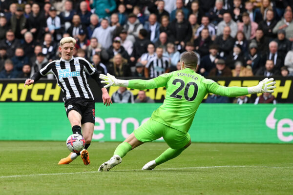 NEWCASTLE UPON TYNE, ENGLAND - APRIL 23: Anthony Gordon of Newcastle United shoots past Fraser Forster of Tottenham Hotspur during the Premier League match between Newcastle United and Tottenham Hotspur at St. James Park on April 23, 2023 in Newcastle upon Tyne, England. 