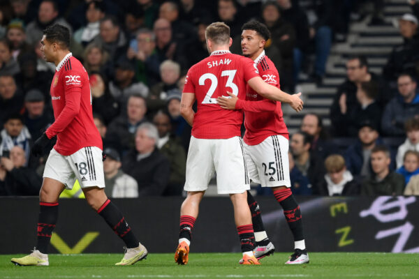 LONDON, ENGLAND - APRIL 27: Jadon Sancho of Manchester United celebrates with Luke Shaw after scoring the team's first goal during the Premier League match between Tottenham Hotspur and Manchester United at Tottenham Hotspur Stadium on April 27, 2023 in London, England. 