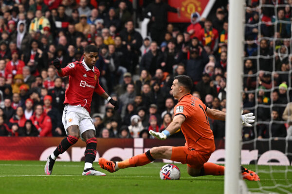 Aston Villa's Argentinian goalkeeper Emiliano Martinez (R) stops the ball shot by Manchester United's English striker Marcus Rashford (L) during the English Premier League football match between Manchester United and Aston Villa at Old Trafford in Manchester, north west England, on April 30, 2023. (Photo by Oli SCARFF / AFP) / RESTRICTED TO EDITORIAL USE. No use with unauthorized audio, video, data, fixture lists, club/league logos or 'live' services. Online in-match use limited to 120 images. An additional 40 images may be used in extra time. No video emulation. Social media in-match use limited to 120 images. An additional 40 images may be used in extra time. No use in betting publications, games or single club/league/player publications. / 