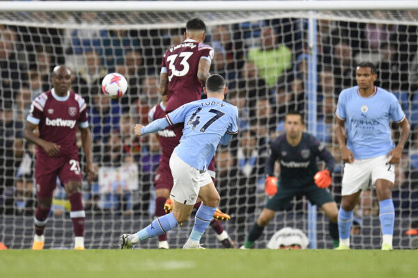 Manchester City's English midfielder Phil Foden shoots and scores his team third during the English Premier League football match between Manchester City and West Ham at the Etihad Stadium in Manchester, north west England, on May 3, 2023. (Photo by Oli SCARFF / AFP) / RESTRICTED TO EDITORIAL USE. No use with unauthorized audio, video, data, fixture lists, club/league logos or 'live' services. Online in-match use limited to 120 images. An additional 40 images may be used in extra time. No video emulation. Social media in-match use limited to 120 images. An additional 40 images may be used in extra time. No use in betting publications, games or single club/league/player publications. / 