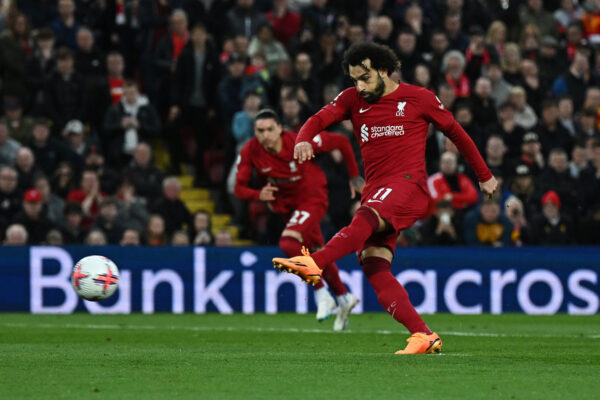 Liverpool's Egyptian striker Mohamed Salah shoots a penalty kick and scores his team first goal during the English Premier League football match between Liverpool and Fulham at Anfield in Liverpool, north west England on May 3, 2023. (Photo by Paul ELLIS / AFP) / RESTRICTED TO EDITORIAL USE. No use with unauthorized audio, video, data, fixture lists, club/league logos or 'live' services. Online in-match use limited to 120 images. An additional 40 images may be used in extra time. No video emulation. Social media in-match use limited to 120 images. An additional 40 images may be used in extra time. No use in betting publications, games or single club/league/player publications. / 