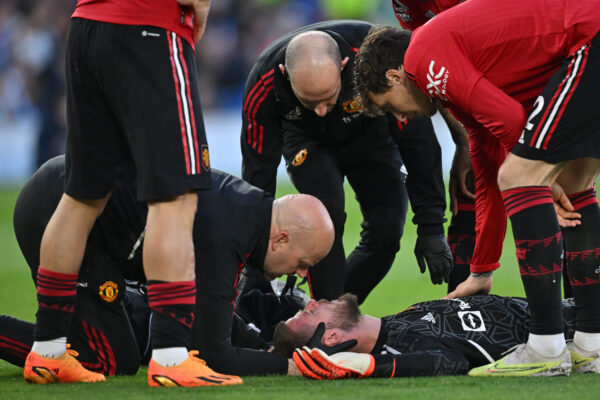 Manchester United's Spanish goalkeeper David de Gea receives medical attention after being hit in the face by the ball during the English Premier League football match between Brighton and Hove Albion and Manchester United at the American Express Community Stadium in Brighton, southern England on May 4, 2023. (Photo by Glyn KIRK / AFP) / RESTRICTED TO EDITORIAL USE. No use with unauthorized audio, video, data, fixture lists, club/league logos or 'live' services. Online in-match use limited to 120 images. An additional 40 images may be used in extra time. No video emulation. Social media in-match use limited to 120 images. An additional 40 images may be used in extra time. No use in betting publications, games or single club/league/player publications. / 