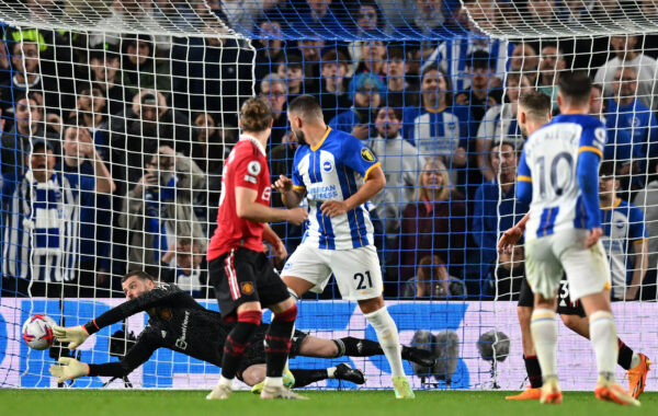 Manchester United's Spanish goalkeeper David de Gea saves a shot from Brighton's Argentinian midfielder Alexis Mac Allister (R) during the English Premier League football match between Brighton and Hove Albion and Manchester United at the American Express Community Stadium in Brighton, southern England on May 4, 2023. (Photo by Glyn KIRK / AFP) / RESTRICTED TO EDITORIAL USE. No use with unauthorized audio, video, data, fixture lists, club/league logos or 'live' services. Online in-match use limited to 120 images. An additional 40 images may be used in extra time. No video emulation. Social media in-match use limited to 120 images. An additional 40 images may be used in extra time. No use in betting publications, games or single club/league/player publications. / 