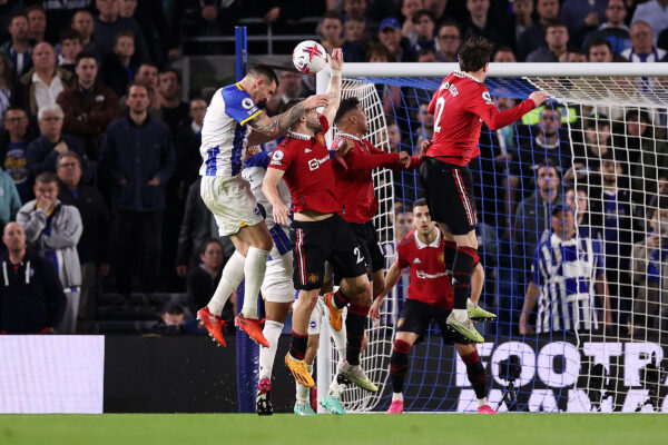 BRIGHTON, ENGLAND - MAY 04: Lewis Dunk of Brighton & Hove Albion shoots which hits the hand of Luke Shaw of Manchester United, which results in a penalty being awarded to Brighton & Hove Albion after a VAR review for handball to during the Premier League match between Brighton & Hove Albion and Manchester United at American Express Community Stadium on May 04, 2023 in Brighton, England. 