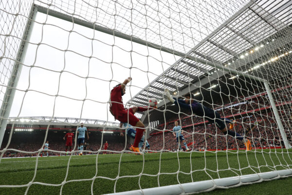Liverpool's Egyptian striker Mohamed Salah (C) kicks to score his team's first goal during the English Premier League football match between Liverpool and Brentford at Anfield in Liverpool, north west England on May 6, 2023. (Photo by DARREN STAPLES / AFP) / RESTRICTED TO EDITORIAL USE. No use with unauthorized audio, video, data, fixture lists, club/league logos or 'live' services. Online in-match use limited to 120 images. An additional 40 images may be used in extra time. No video emulation. Social media in-match use limited to 120 images. An additional 40 images may be used in extra time. No use in betting publications, games or single club/league/player publications. / 