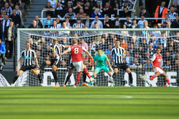 Arsenal's Norwegian midfielder Martin Odegaard (C) shoots and scores his team's first goal during the English Premier League football match between Newcastle United and Arsenal at St James' Park in Newcastle-upon-Tyne, north east England on May 7, 2023. (Photo by Lindsey Parnaby / AFP) / RESTRICTED TO EDITORIAL USE. No use with unauthorized audio, video, data, fixture lists, club/league logos or 'live' services. Online in-match use limited to 120 images. An additional 40 images may be used in extra time. No video emulation. Social media in-match use limited to 120 images. An additional 40 images may be used in extra time. No use in betting publications, games or single club/league/player publications. / 