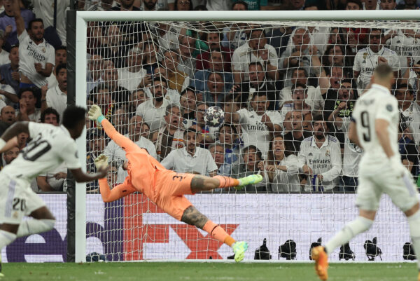 Real Madrid's Brazilian forward Vinicius Junior scores his team's first goal during the UEFA Champions League semi-final first leg football match between Real Madrid CF and Manchester City at the Santiago Bernabeu stadium in Madrid on May 9, 2023. (Photo by Thomas COEX / AFP)