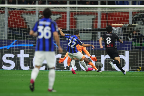 MILAN, ITALY - MAY 10: Henrikh Mkhitaryan of FC Internazionale scores the team's second goal whilst under pressure from Sandro Tonali of AC Milan during the UEFA Champions League semi-final first leg match between AC Milan and FC Internazionale at San Siro on May 10, 2023 in Milan, Italy. 