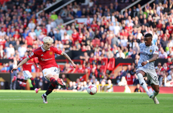 MANCHESTER, ENGLAND - MAY 13: Alejandro Garnacho of Manchester United scores the team's second goal whilst under pressure from Nelson Semedo of Wolverhampton Wanderers during the Premier League match between Manchester United and Wolverhampton Wanderers at Old Trafford on May 13, 2023 in Manchester, England. 