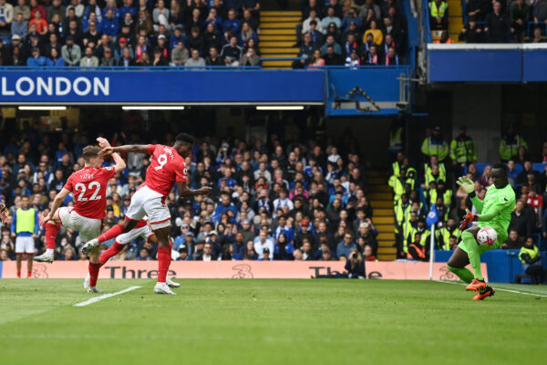 Nottingham Forest's Nigerian striker Taiwo Awoniyi (C) scores his team's second goal past Chelsea's French-born Senegalese goalkeeper Edouard Mendy (R) during the English Premier League football match between Chelsea and Nottingham Forest at Stamford Bridge in London on May 13, 2023. (Photo by Glyn KIRK / AFP) / RESTRICTED TO EDITORIAL USE. No use with unauthorized audio, video, data, fixture lists, club/league logos or 'live' services. Online in-match use limited to 120 images. An additional 40 images may be used in extra time. No video emulation. Social media in-match use limited to 120 images. An additional 40 images may be used in extra time. No use in betting publications, games or single club/league/player publications. / 