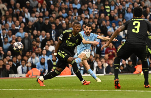 Manchester City's Portuguese midfielder Bernardo Silva (C) scores the opening goal during the UEFA Champions League second leg semi-final football match between Manchester City and Real Madrid at the Etihad Stadium in Manchester, north west England, on May 17, 2023. (Photo by Paul ELLIS / AFP) 
